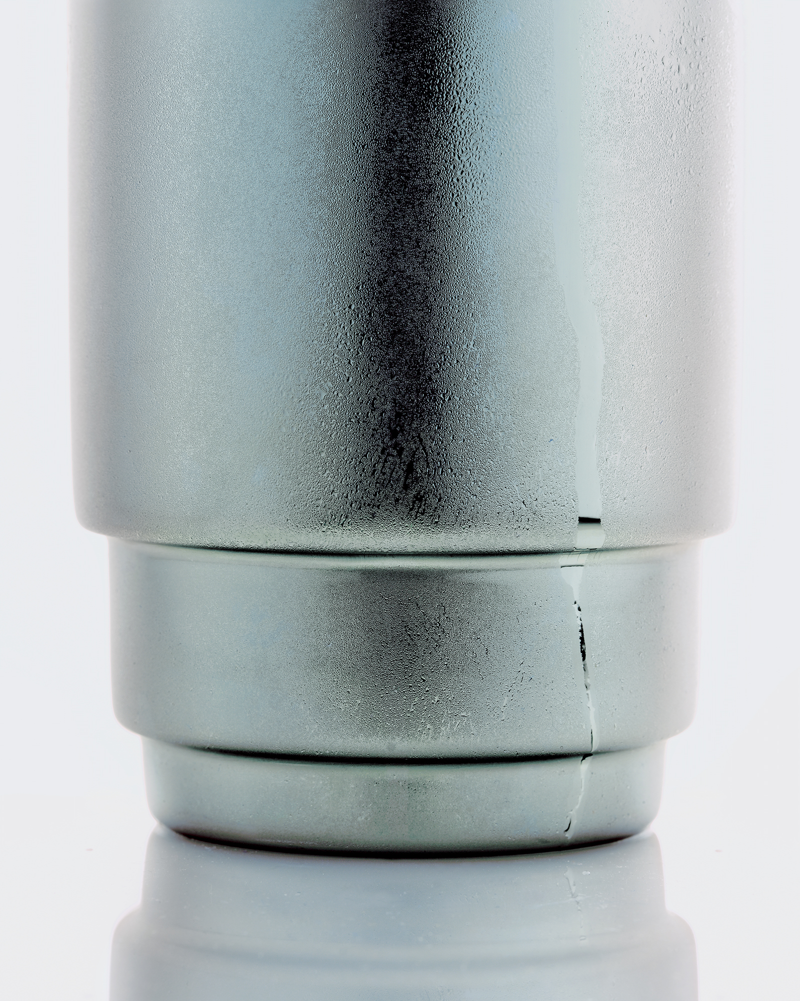 Close-up of a silver HAY shaker with soft, brushed texture and minimalist background. 